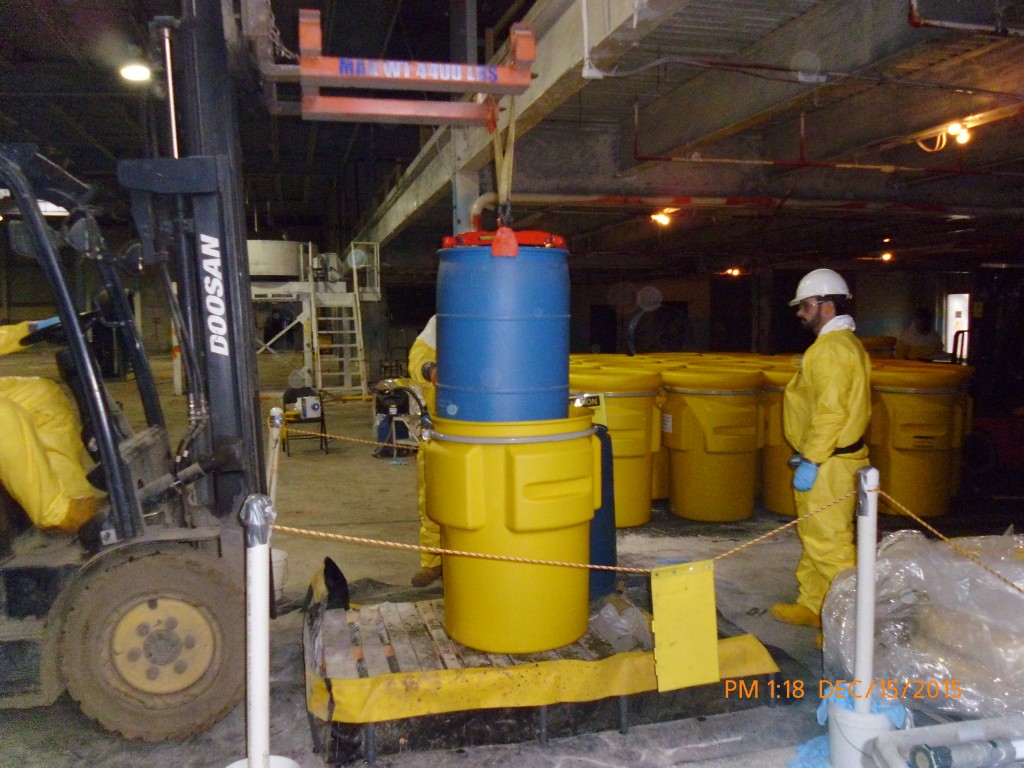 Loading acid overpack prior to shipment off-site.